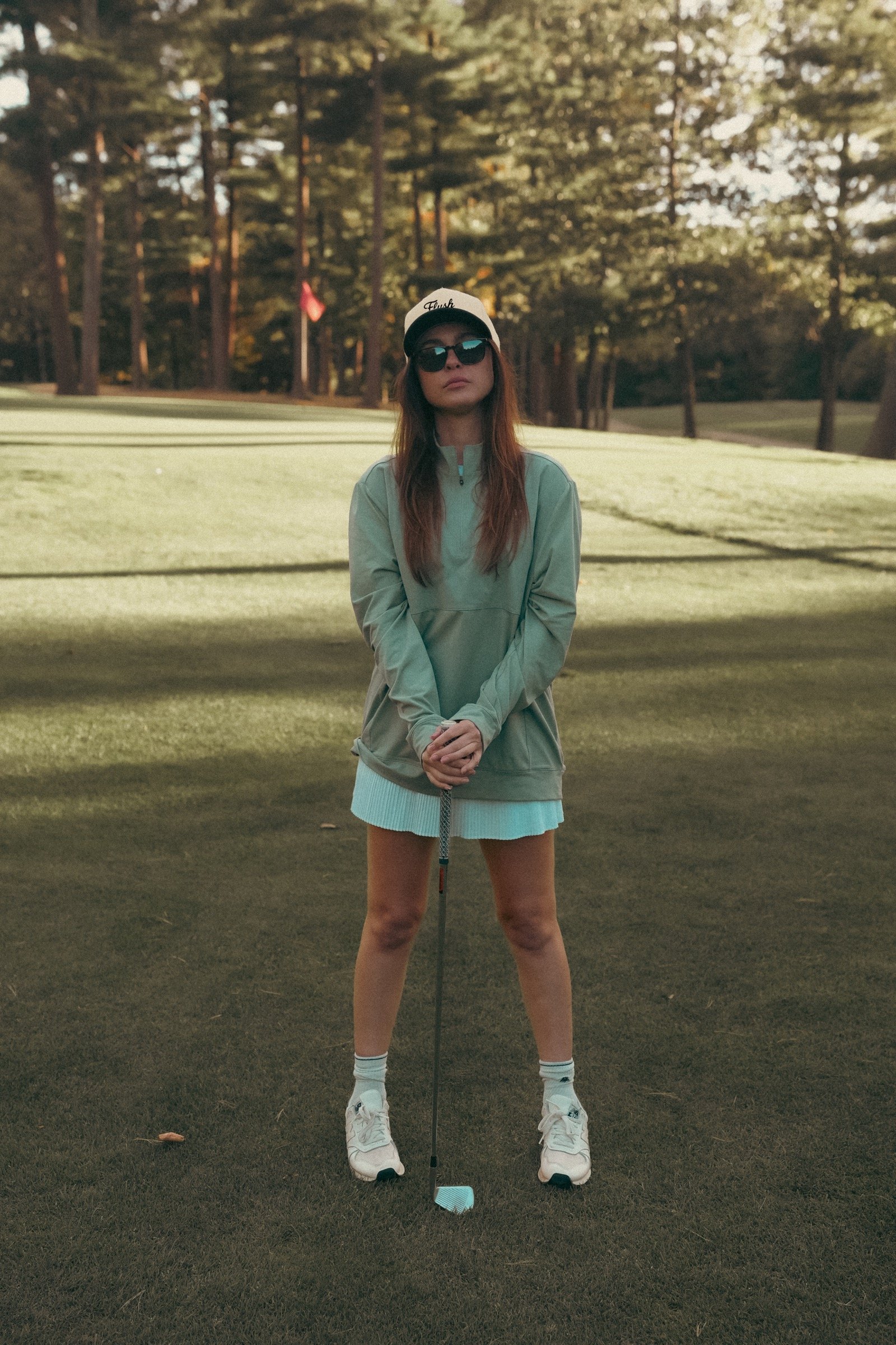 Britt standing on the green in Flush Golf apparel