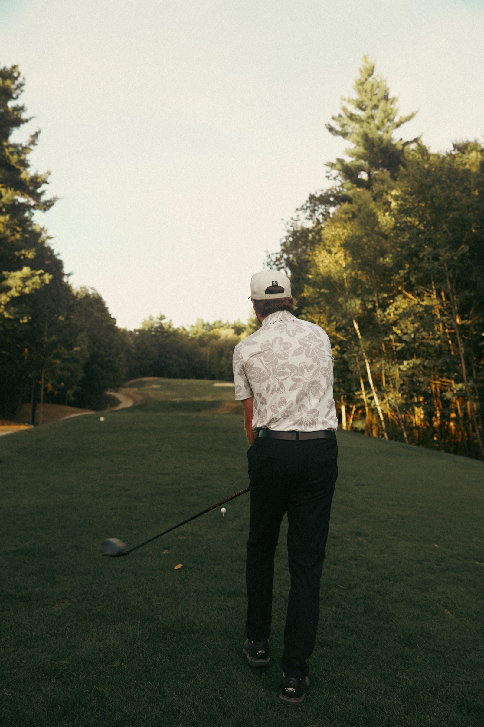 Cory wearing a Flush Golf hat on the course